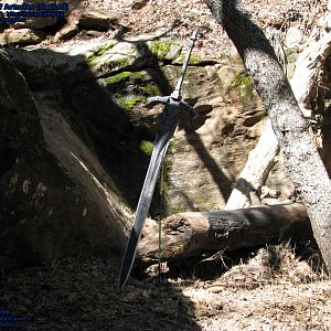 My meticulously scaled (accurately life-size!) Cursed Greatsword of Artorias papercraft, BEFORE fiberglass resin has been applied to it. In this pic, it's just "110lb" paper + a lightweight steel tomato plant stake, and probably still weighed under 1.5lbs. as a whole. Pic taken near Sedona, Arizona, USA, during a recent road trip.